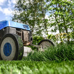 A lawnmower mowing grass